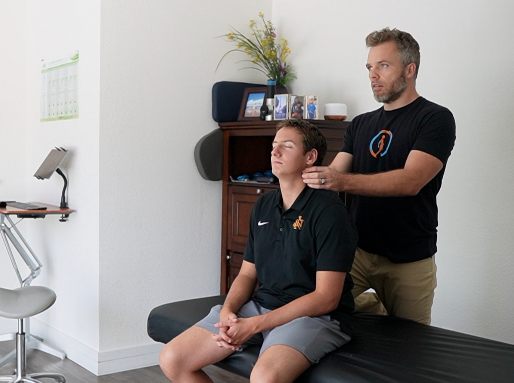 Julian from Pain and Perfomance Solutions working on a client with headaches