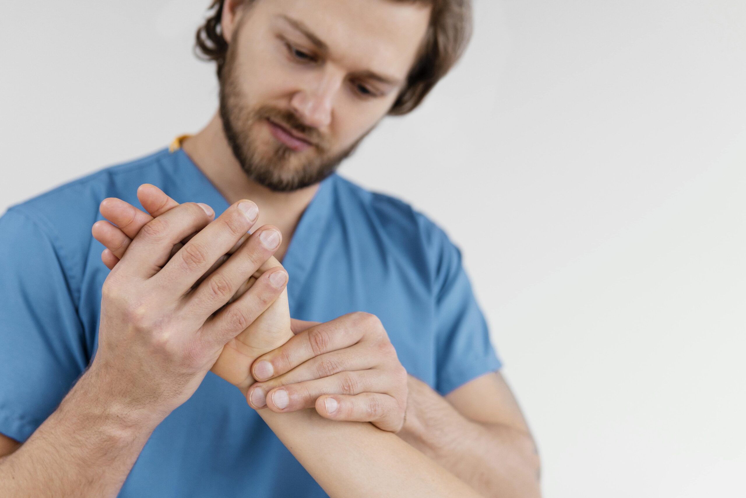 male medical professional examining a woman's wrist