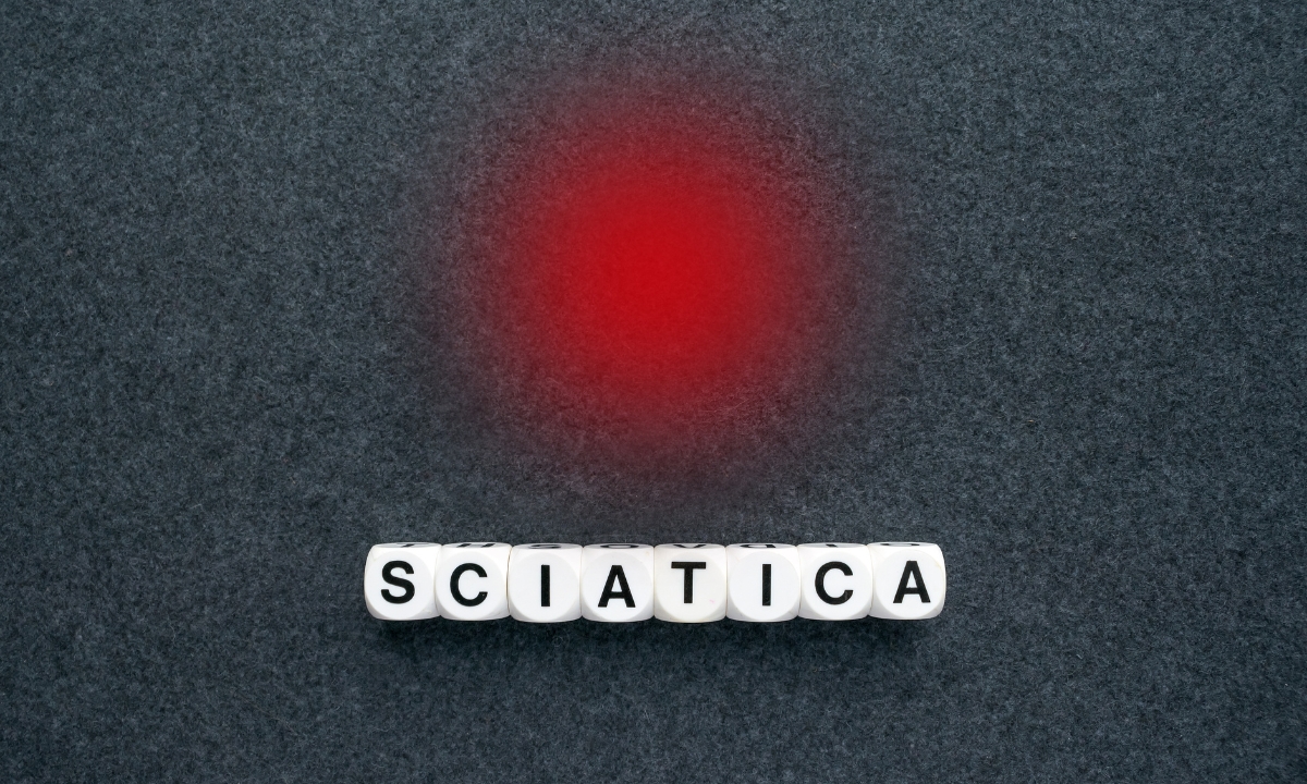 dice that spell out "sciatica" and an airbrushed red dot