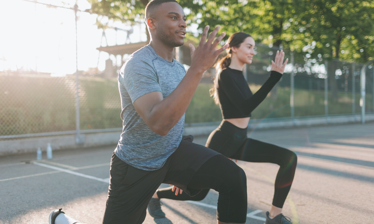 two people outside doing lunges